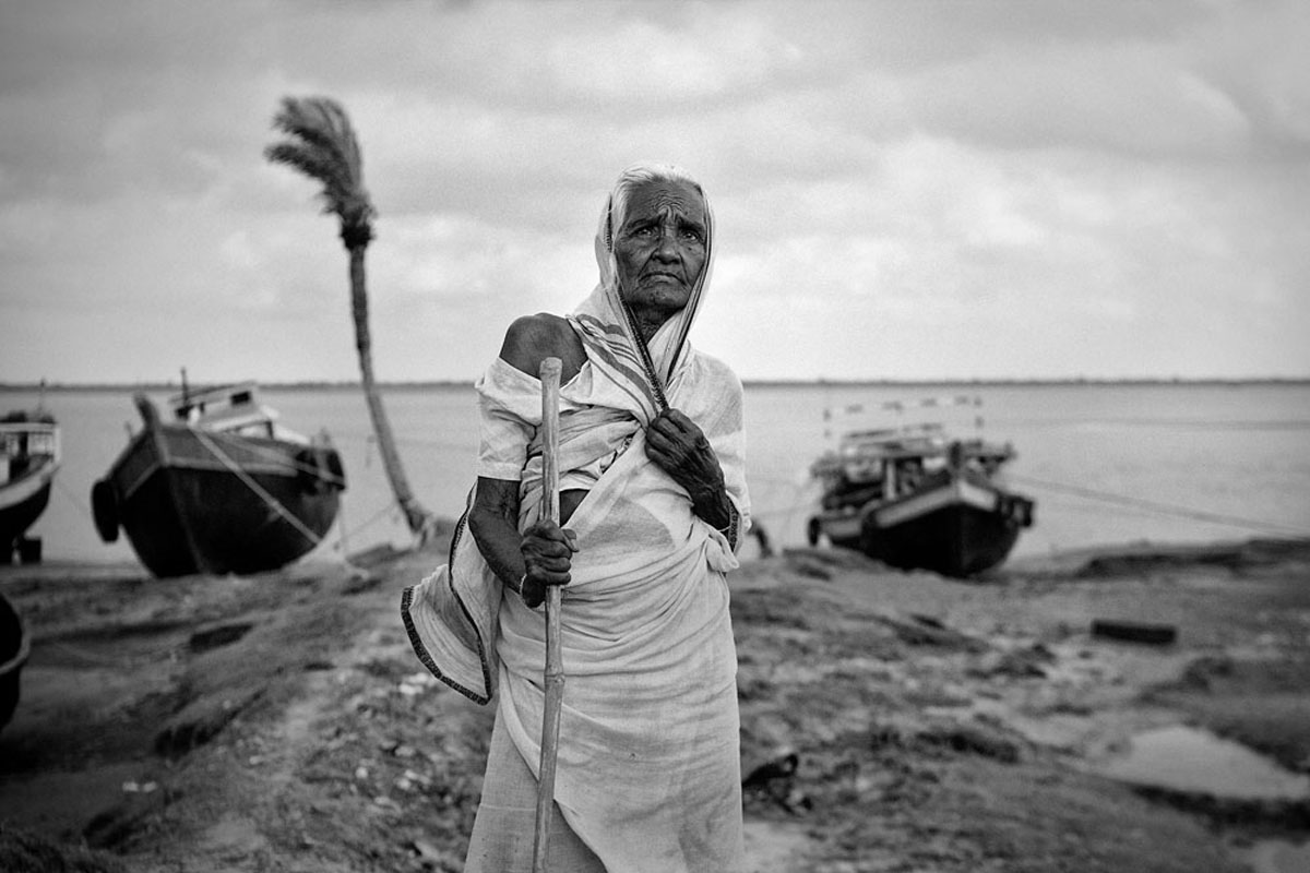 An old lady waiting for the fishermen to return with the days catch. She has spent all her life on this vanishing island.